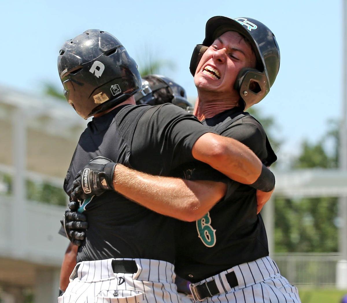 Coral Reef HS Brent Cosulluela (5) and Michael Ogden (6) celebrate after they both scored in the third inning Timber Creek HS in the FHSAA Semi-Final Class 9A Division at CenturyLink Sports Complex - Hammond Stadium in Fort Myers, Florida, Thursday, May, 30, 2019.