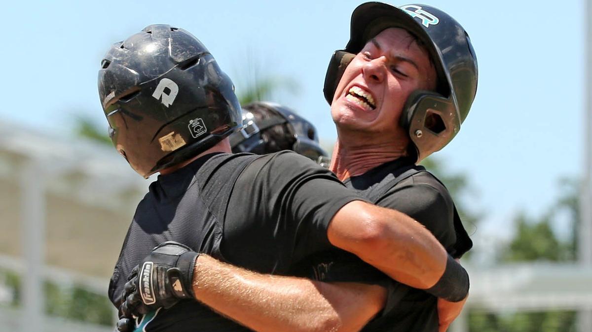 Coral Reef HS Brent Cosulluela (5) and Michael Ogden (6) celebrate after they both scored in the third inning Timber Creek HS in the FHSAA Semi-Final Class 9A Division at CenturyLink Sports Complex - Hammond Stadium in Fort Myers, Florida, Thursday, May, 30, 2019.
