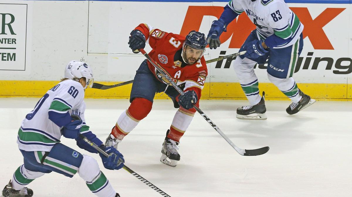 Florida Panthers Vincent Trocheck advances the puck past Vancouver Canucks Markus Granlund in the first period at the BB&T Center in Sunrise on Oct. 13, 2018.