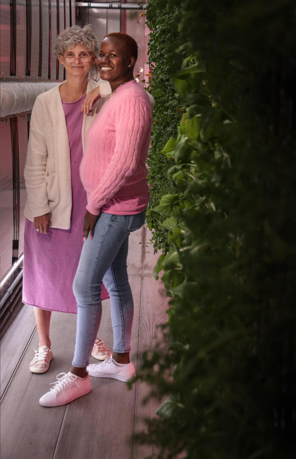 Constance Collins, left, founder of Lotus Village, and Georgette Madison inside the Village’s hydroponic farm. Madison, a former resident, is now employed as director of guest services.