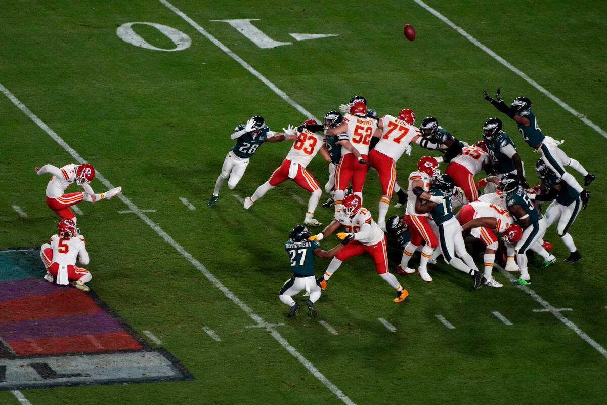 Kansas City Chiefs place kicker Harrison Butker (7) kicks the game-winning field goal as punter Tommy Townsend (5) holds during the second half of the NFL Super Bowl 57 football game against the Philadelphia Eagles, Sunday, Feb. 12, 2023, in Glendale, Ariz. (AP Photo/Charlie Riedel)