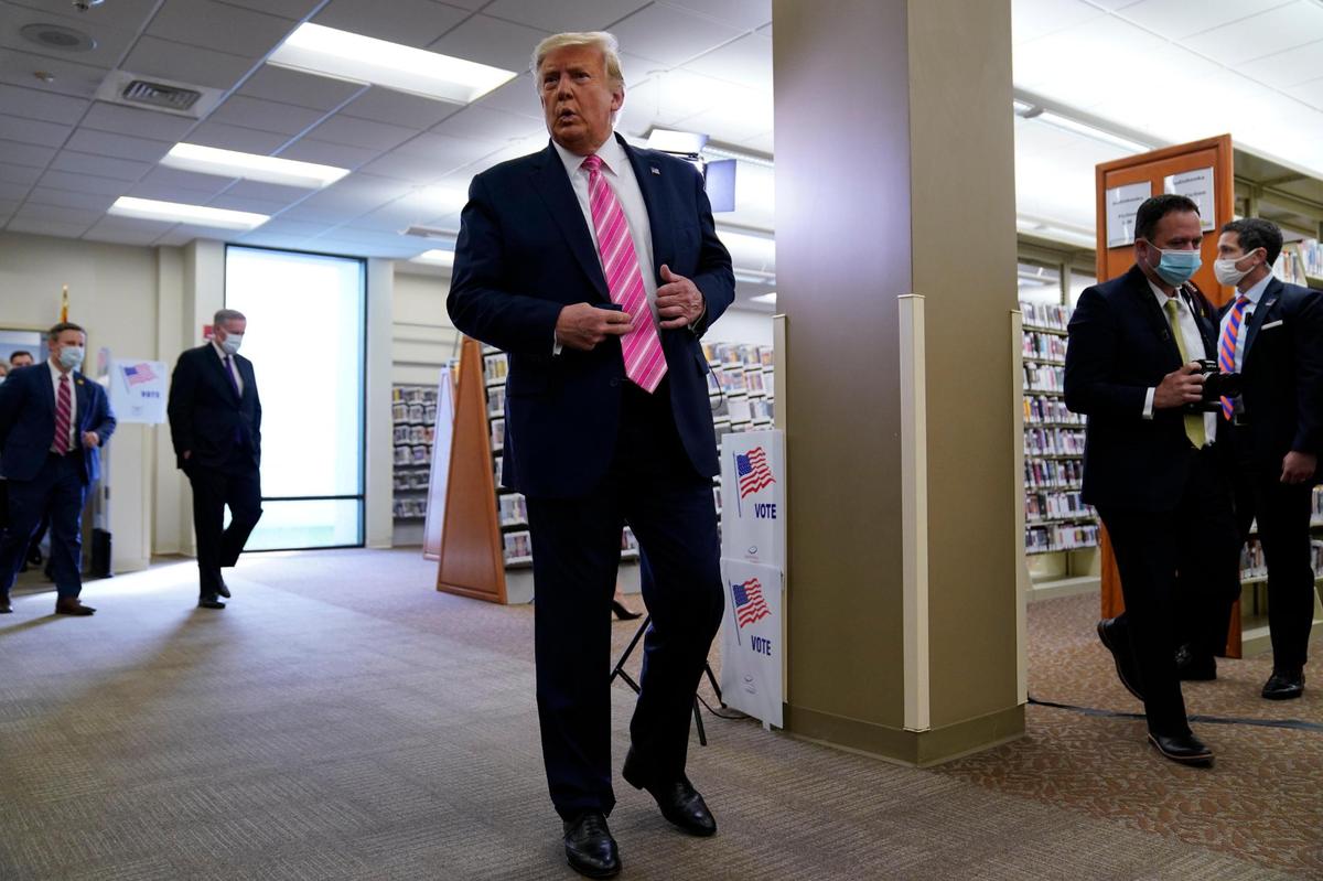 President Donald Trump talks with reporters after casting his ballot in the presidential election, Saturday, Oct. 24, 2020, in West Palm Beach, Florida.