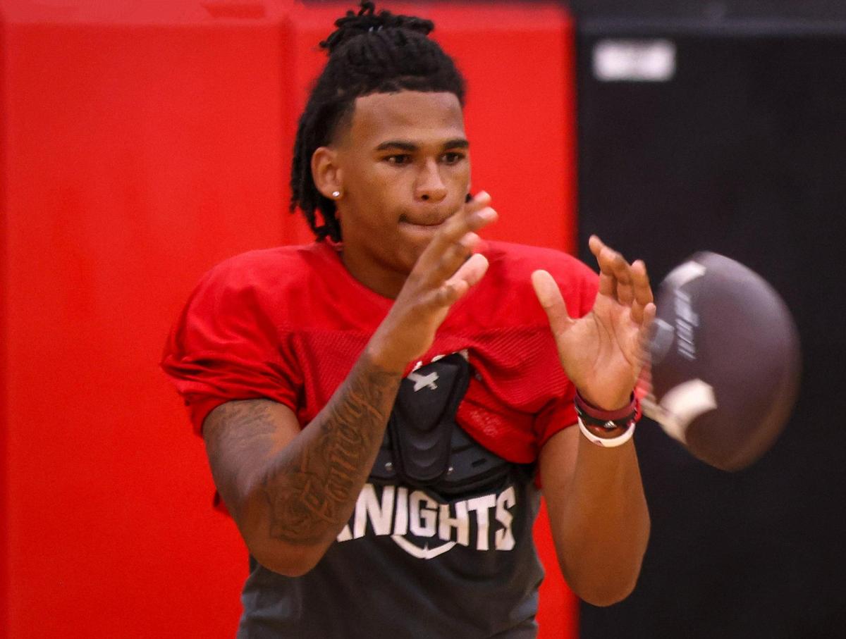 Monarch High football quarterback A.J. Hairston takes snaps as the team held their practice inside the school’s gym due to bad weather and lightning on Monday, July 31, 2023 in Coconut Creek, Florida.