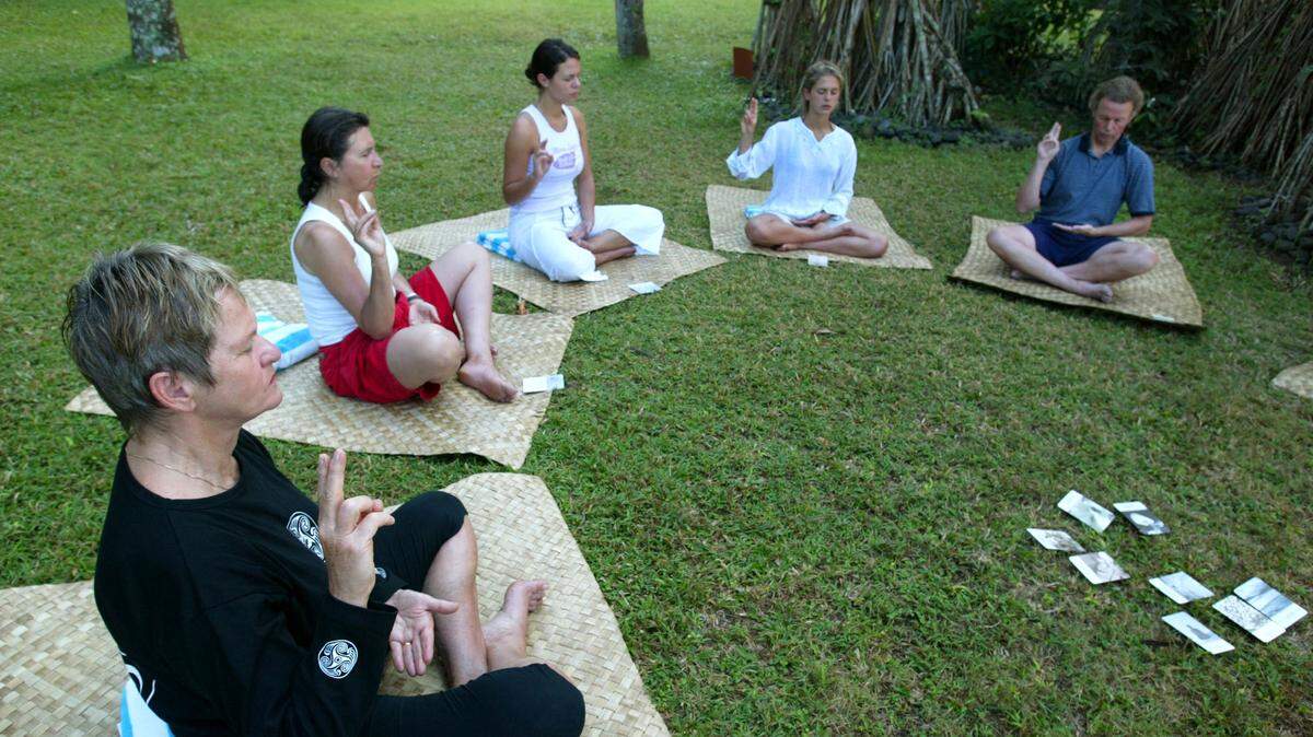 Tourists take part in the daily afternoon yoga class at the Serai Hotel July 31, 2002 in Manggis, Bali, Indonesia.