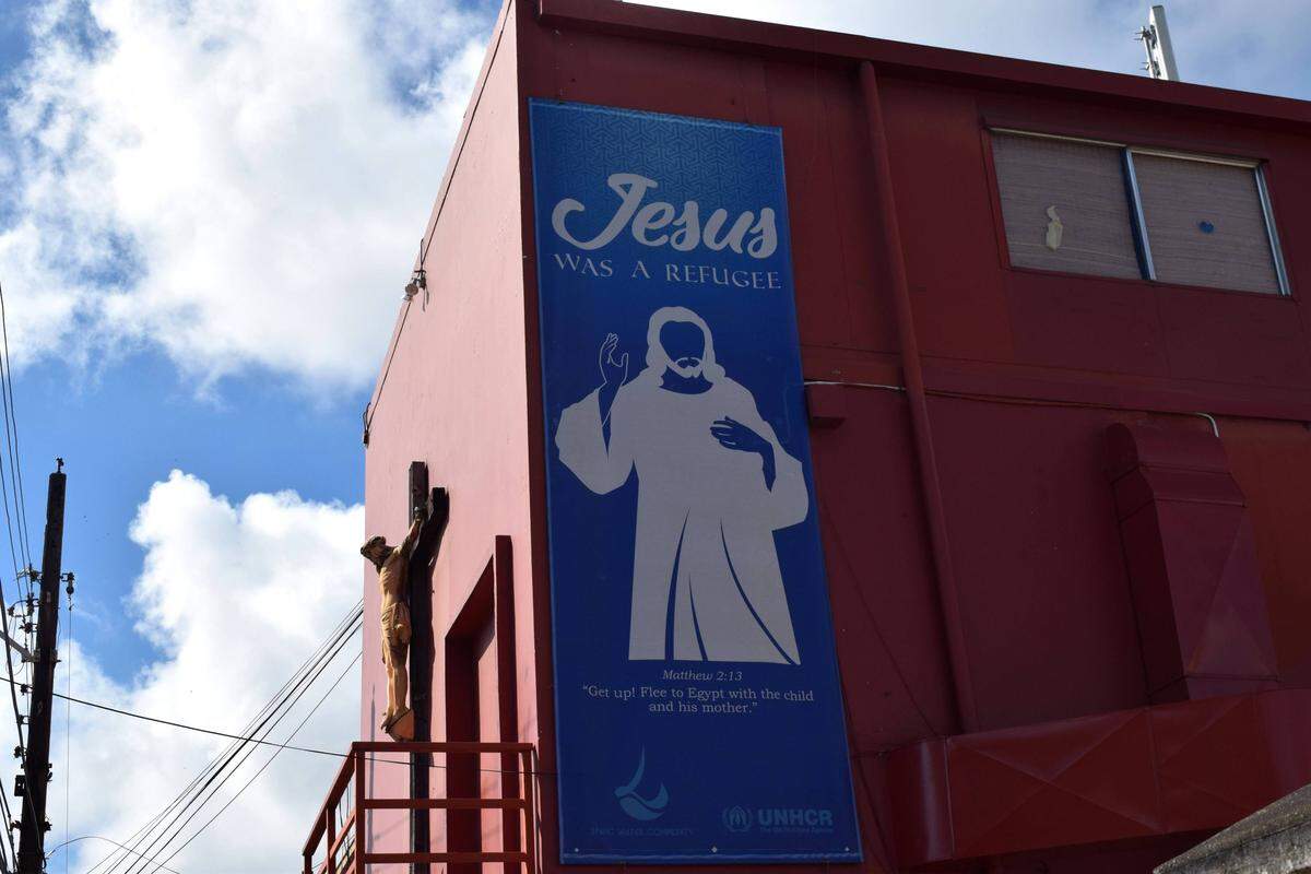 A billboard outside of Living Water Community, an NGO that works with asylum seekers, in Port of Spain, Trinidad. The island is thought to be home to more than 40,000 Venezuelans, many of them living there as undocumented migrants.
