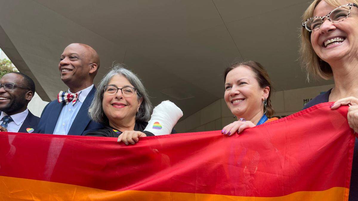 Miami-Dade Mayor Daniella Levine Cava, third from left, looks over a Pride flag before it was raised above the Stephen P. Clark County Hall facility on Wednesday, June 7, 2023. Joining her, from left: State Sen. Shevrin Jones, D-Miami Gardens; Oliver Gilbert, chairman of the Miami-Dade County Commission; Sarah Kavanagh, Ireland’s consul general in Miami; and Eileen Higgins, a Miami-Dade commissioner.