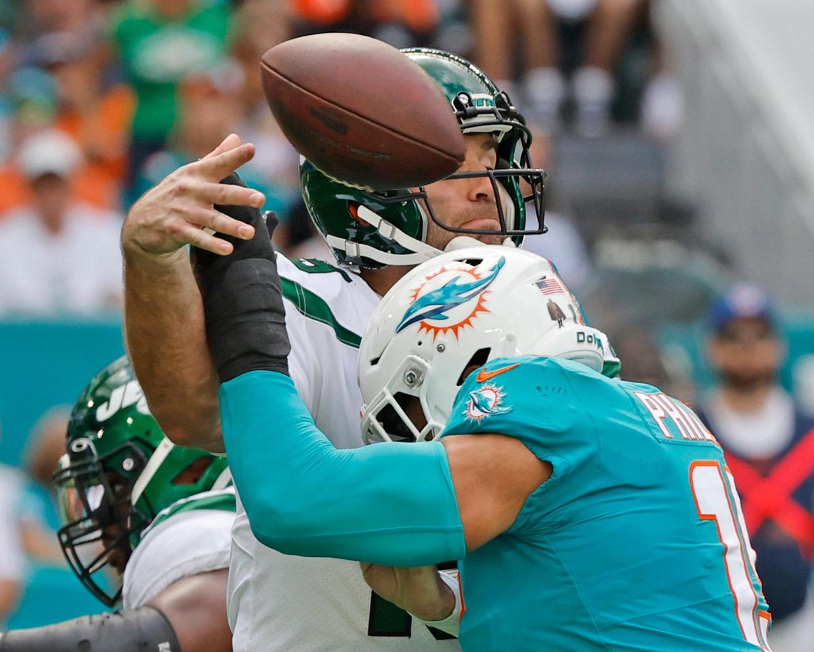 Miami Dolphins linebacker Jaelan Phillips (15) defends against New York Jets quarterback Joe Flacco (19) who throws an incomplete pass in the second quarter at Hard Rock Stadium in Miami Gardens on Sunday, January 8, 2023.