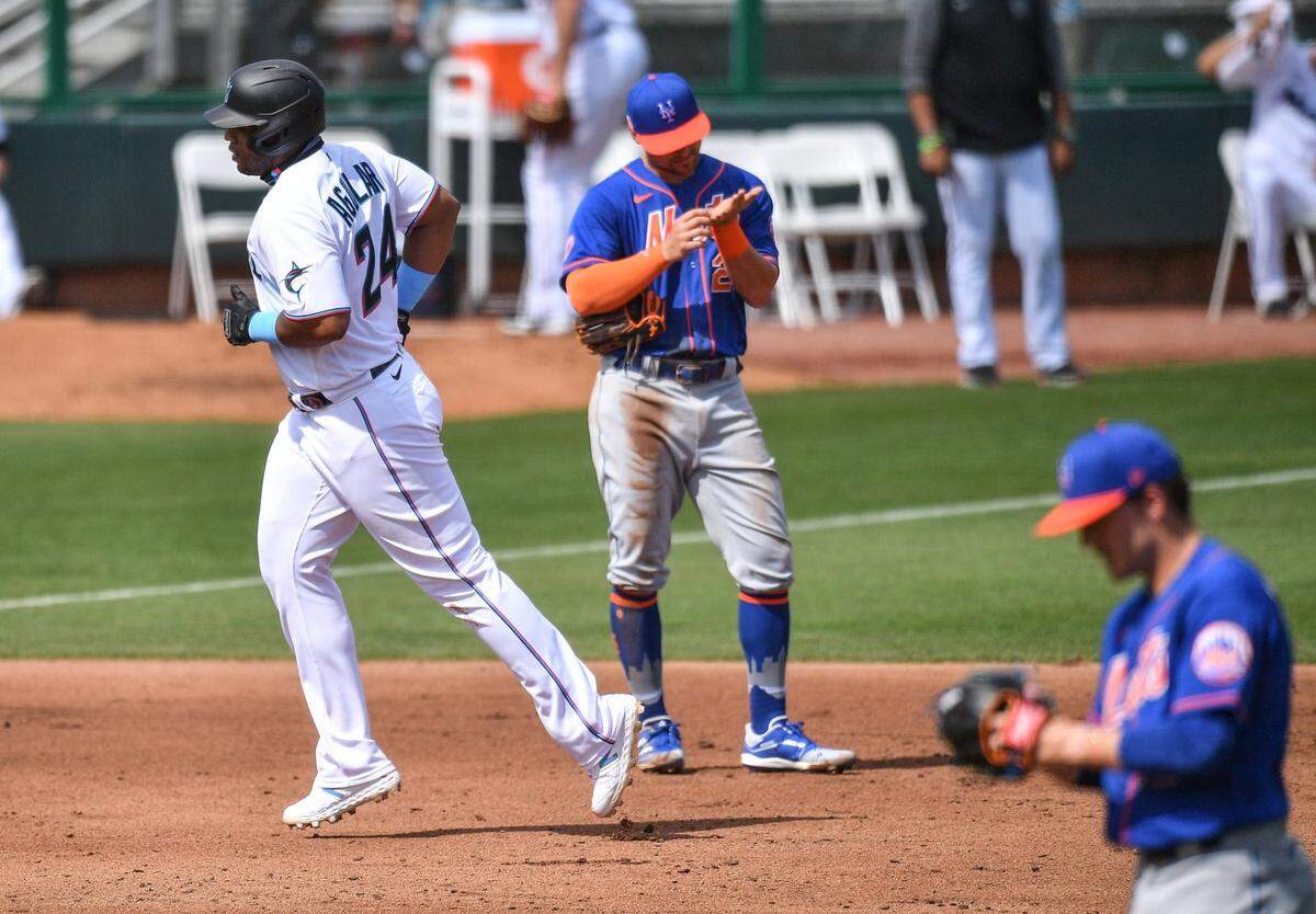 J.D. Davis #28 of the New York Mets ignores Jesus Aguilar #24 of the Miami Marlins as he runs the bases after hitting a two run homerun in the fourth inning against the New York Mets in a spring training game at Roger Dean Chevrolet Stadium on March 01, 2021 in Jupiter, Florida.