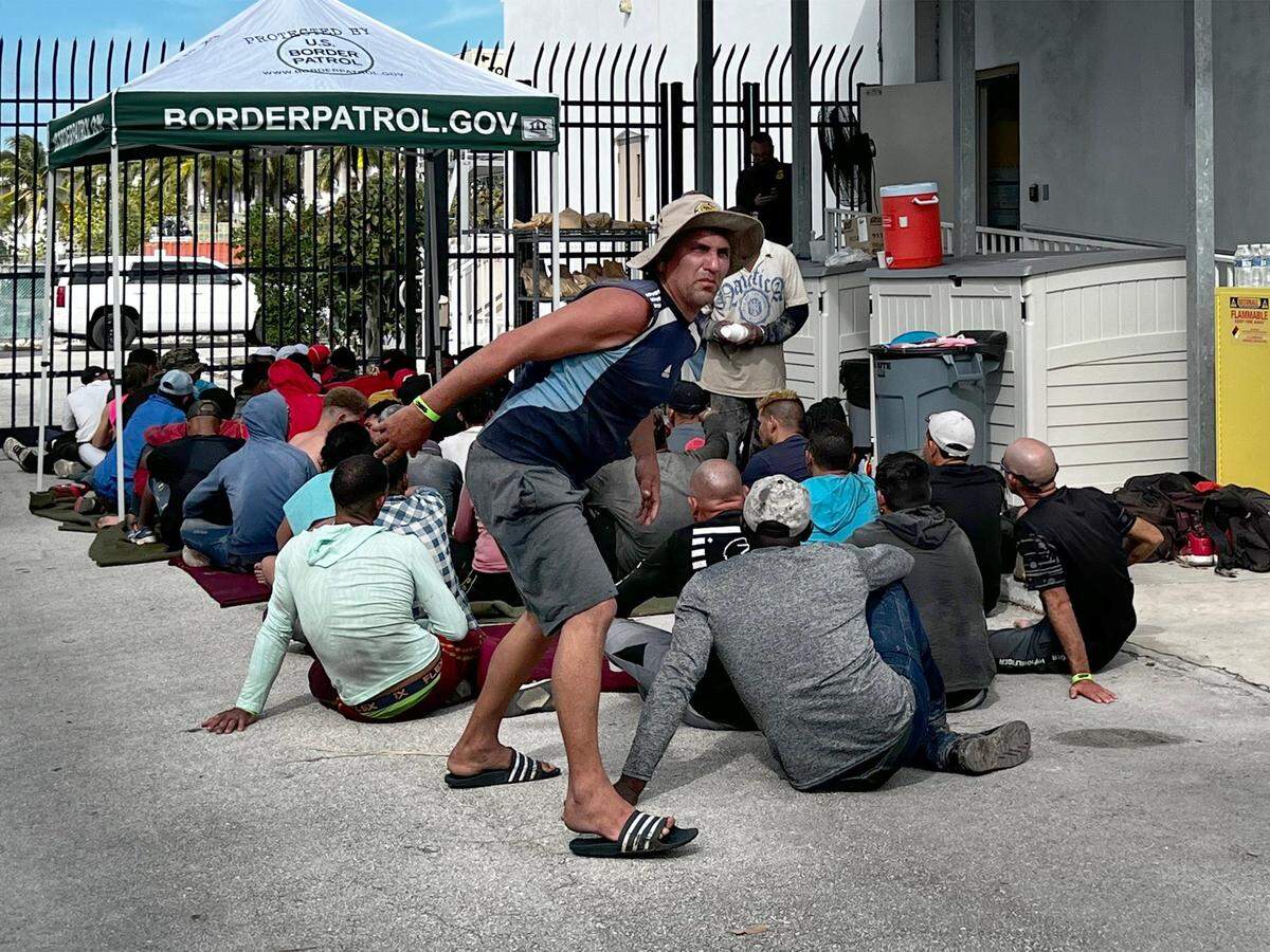 Cuban migrants wait to be processed by U.S. Border Patrol agents at the agency’s station in the Florida Keys city of Marathon on Wednesday, Jan. 4, 2023. About 40 men, women and small children were among those at the Border Patrol center. On Thursday, Jan. 5, 2023, the U.S. Coast Guard shipped 337 Cuban migrants from Dry Tortugas National Park in the Florida Keys to Key West. They were then transported by seven buses to Border Patrol centers in South Florida.