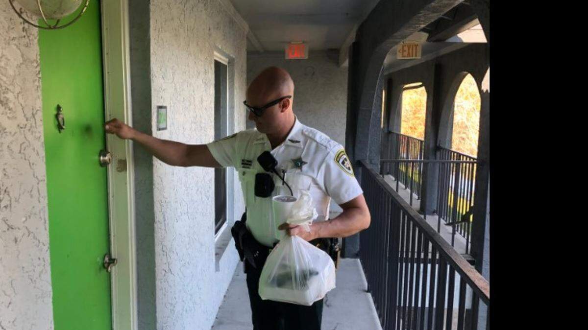 A deputy delivers food after the DoorDash driver was arrested