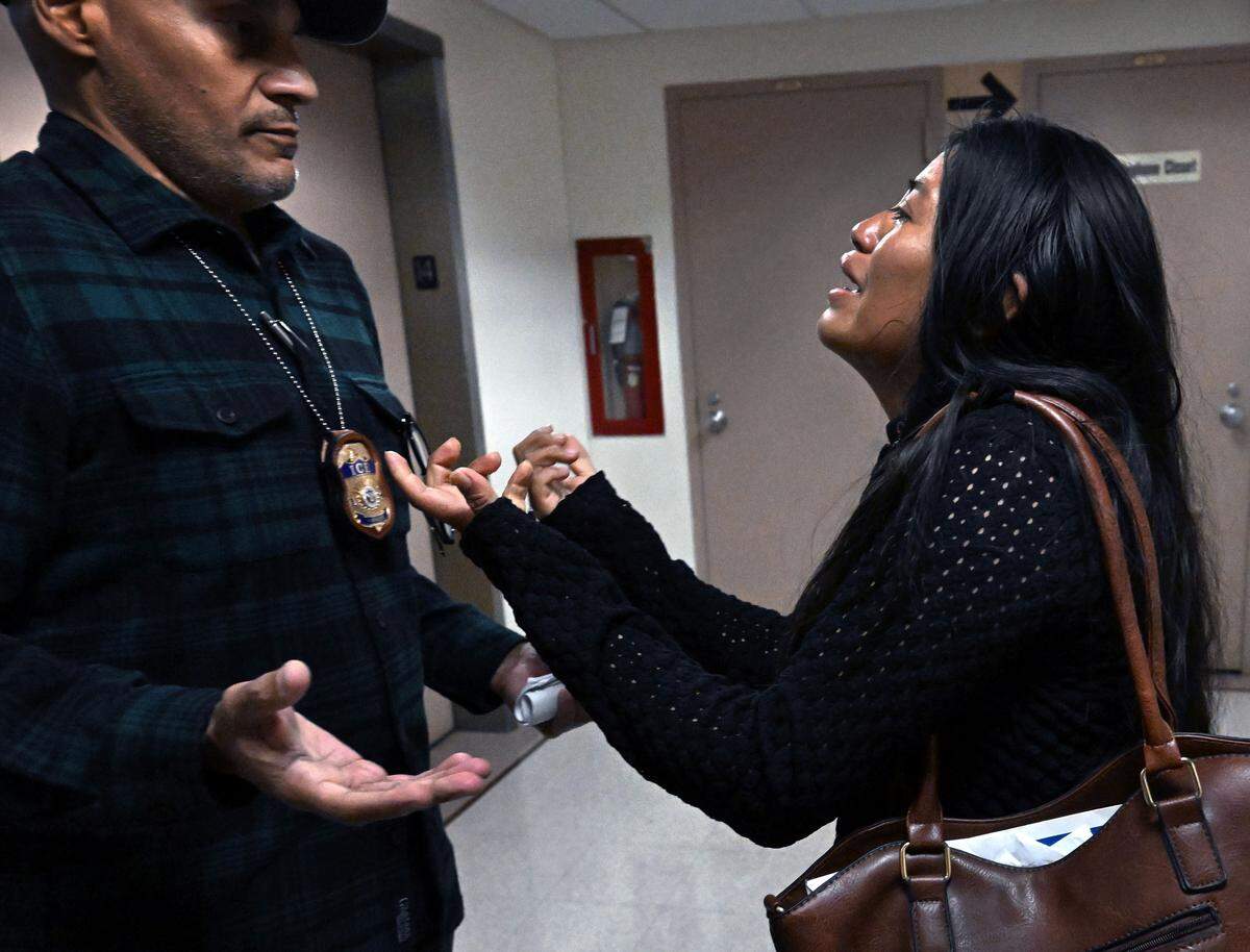 Monica, a  woman from Ecuador, pleads with an ICE officer after she and her children were pulled away from her husband Ruben as he was detained by ICE after his immigration court hearing at the Jacob K. Javits Federal Building in New York on Sept. 25, 2025.  