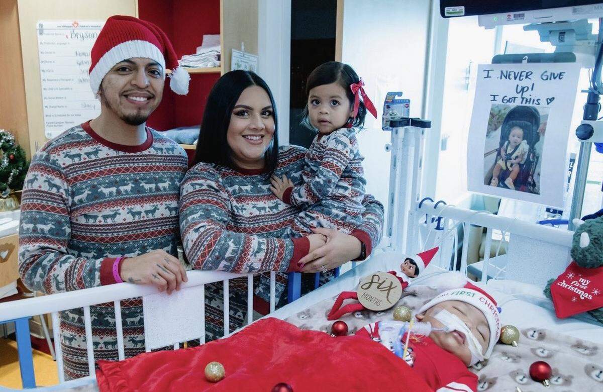 Brandon Gutierrez, 31, his wife, Lilchrist McCoy Alcantara, 33, and their daughter, Lilia, 3, at Bryson’s bedside at Joe DiMaggio Children’s Hospital last December for the baby’s first Christmas. 