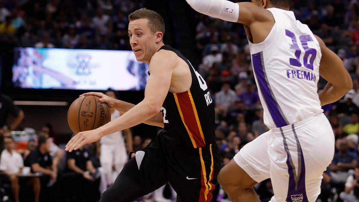Miami Heat forward Duncan Robinson, left, drives to the basket against Sacramento Kings guard Allerik Freeman during the first half of an NBA summer league basketball game Thursday, July 5, 2018, in Sacramento, Calif. Miami has agreed to a two-way deal with Robinson for next season. (AP Photo/Rich Pedroncelli)