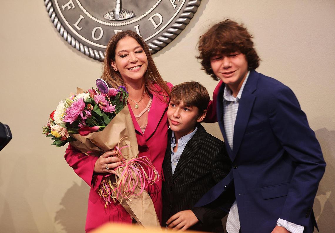 Pedro, far right, and Pablo Caviedes posed with their mother Sabina Covo, after she took the oath in front of Judge Lody Jean, during her swearing-in ceremony at City Hall.