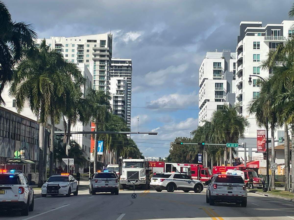 A woman pushing a baby in a stroller across Biscayne Boulevard was killed after being pinned under a dump truck, police said.