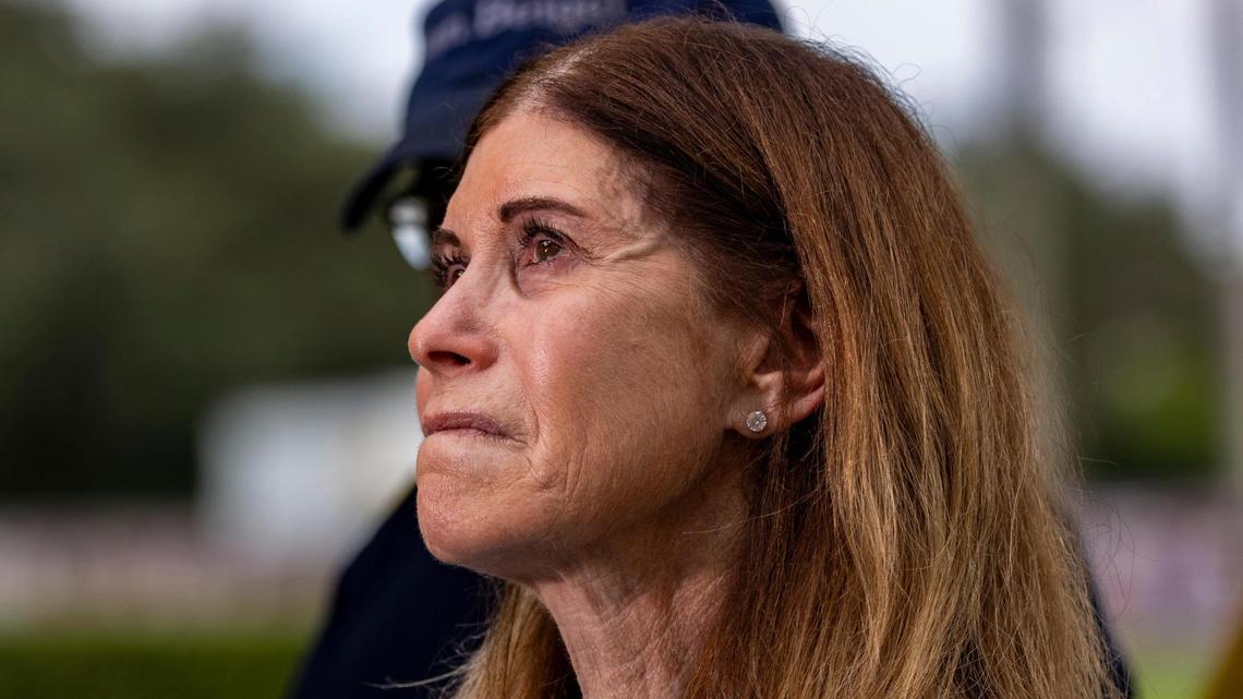 Parkland, Florida - July 5, 2023 - Linda Beigel Schulman, l mother of geography teacher and cross country track coach Scott Beigel who died in the shooting in 2018holds back tears as she talks to the press after visiting the building where her son died. Family members of the shooting victims at Marjory Stoneman Douglas High School visited the scene of the crime. The building will be demolished now that the trials are over.