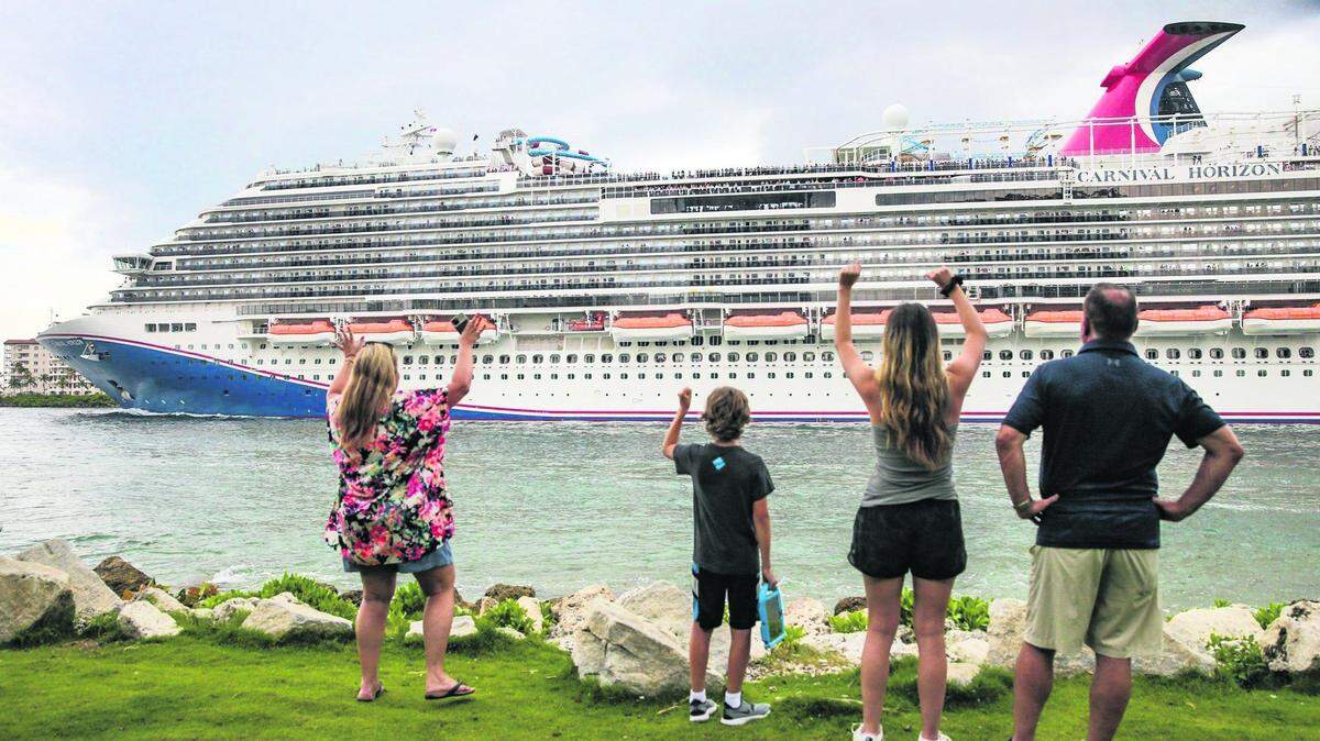 Kim and Scott and their children Hunter and Hayley wave to passengers on the Carnival Horizon Cruise Ship as it heads out to sea on Saturday, June 25, 2022
