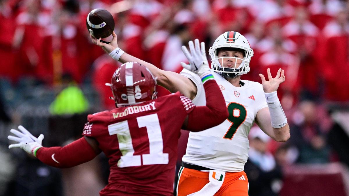 Miami quarterback Tyler Van Dyke (9) throws the ball past the defense of Temple linebacker D.J. Woodbury (11) during the first half of an NCAA college football game, Saturday, Sept. 23, 2023, in Philadelphia. (AP Photo/Derik Hamilton)