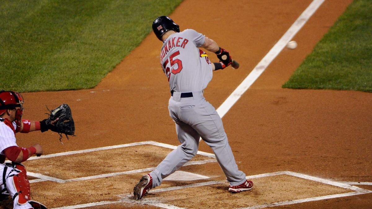 Oct 7, 2011; Philadelphia, PA, USA; St. Louis Cardinals center fielder Skip Schumaker (55) hits an RBI double during the first inning against the Philadelphia Phillies during game five of the 2011 NLDS at Citizens Bank Park.