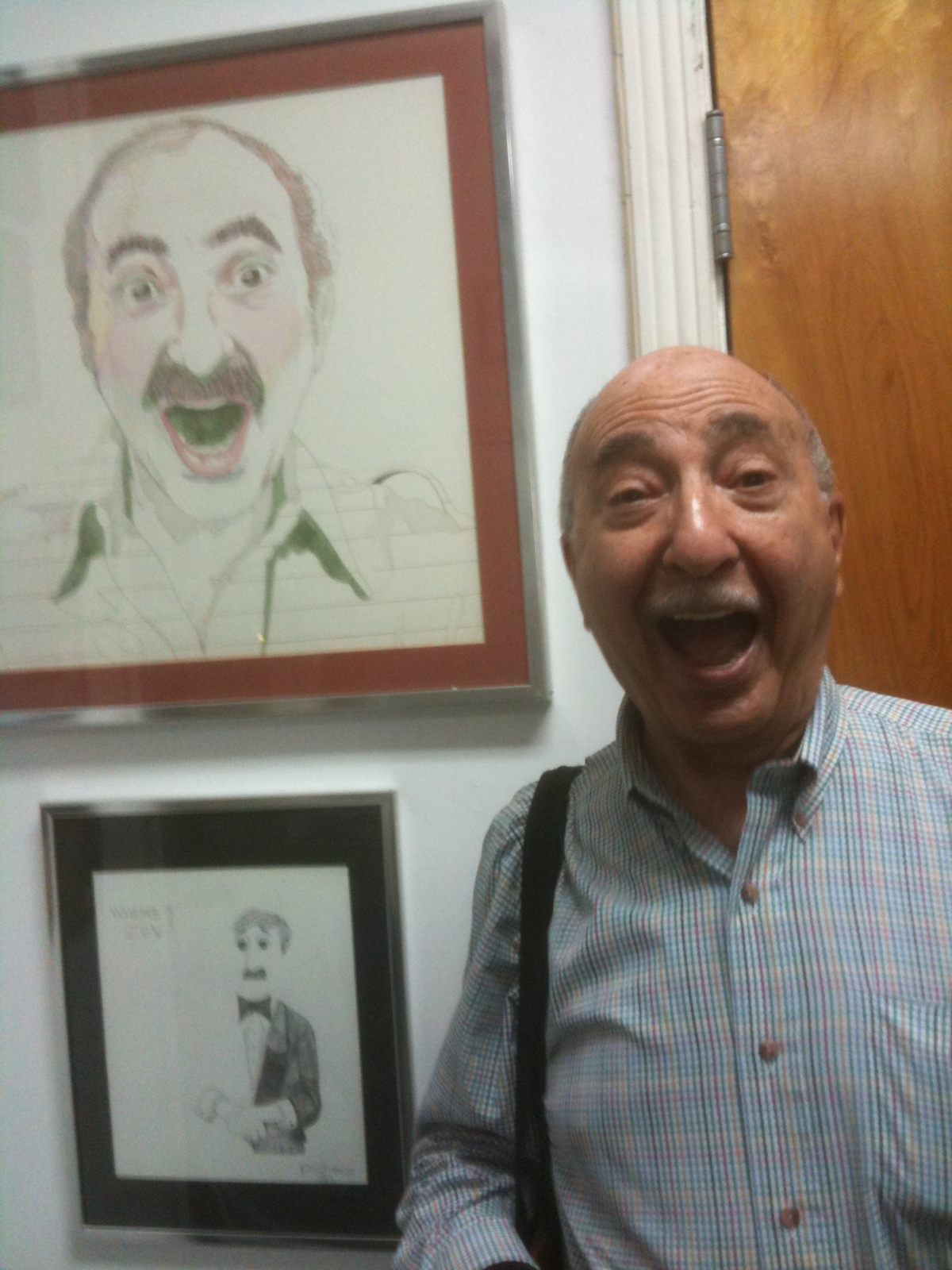 In a spontaneous moment at his office in 2010, Charlie Cinnamon stood beside his 1976 portrait by artist Martin Kreloff and recreated the original pose.