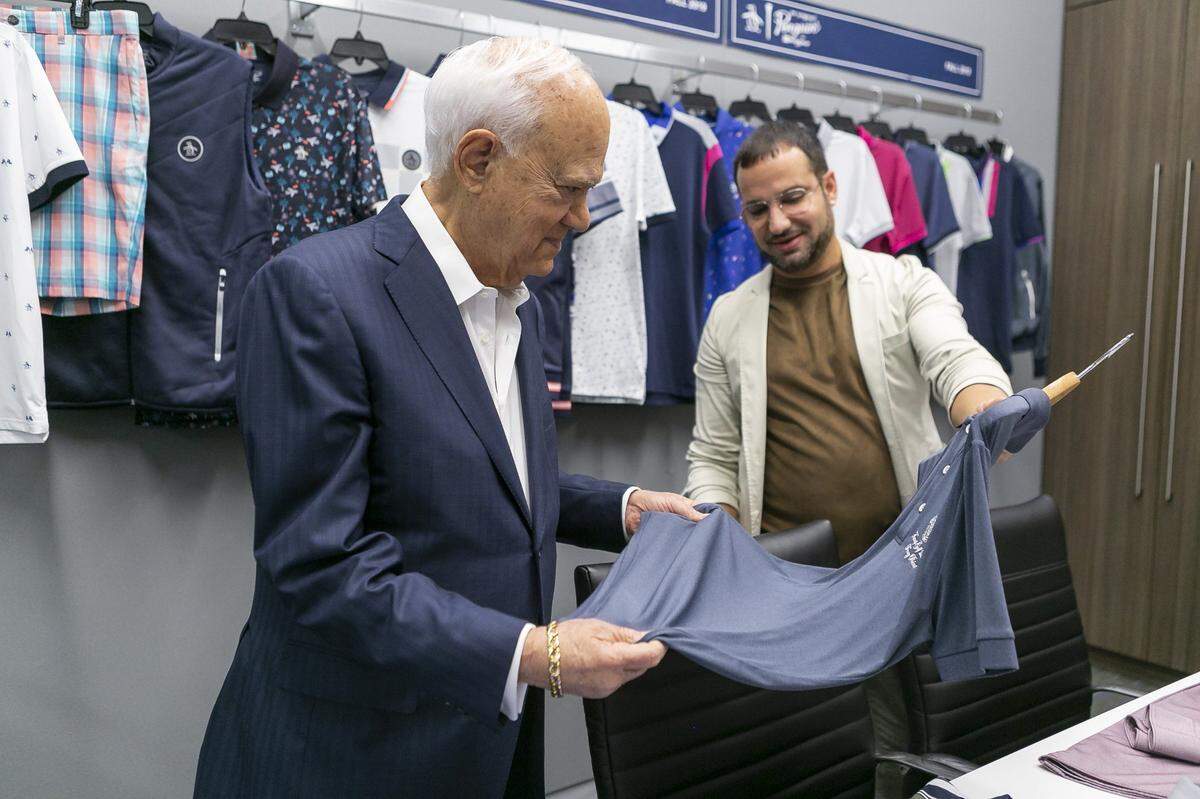 Juan Carlos Alvarez, 40, right, then a senior designer for Original Penguin Golf, talks with George Feldenkreis, the founder of Perry Ellis International, at the company’s headquarters in Doral on Oct. 25, 2018.