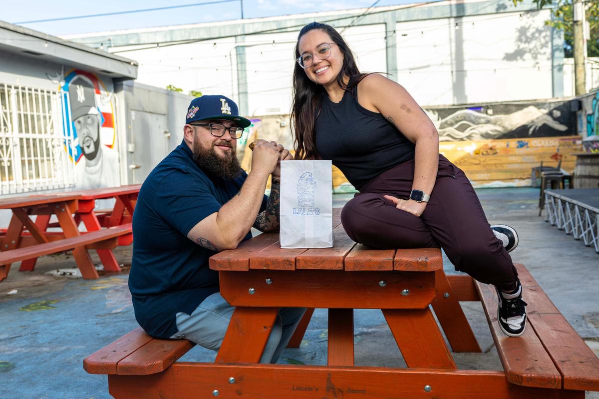 Lala’s Burgers owners Jeff and Laura Budnechky in the beer garden at Lincoln’s Beard Brewing Co. in Miami.