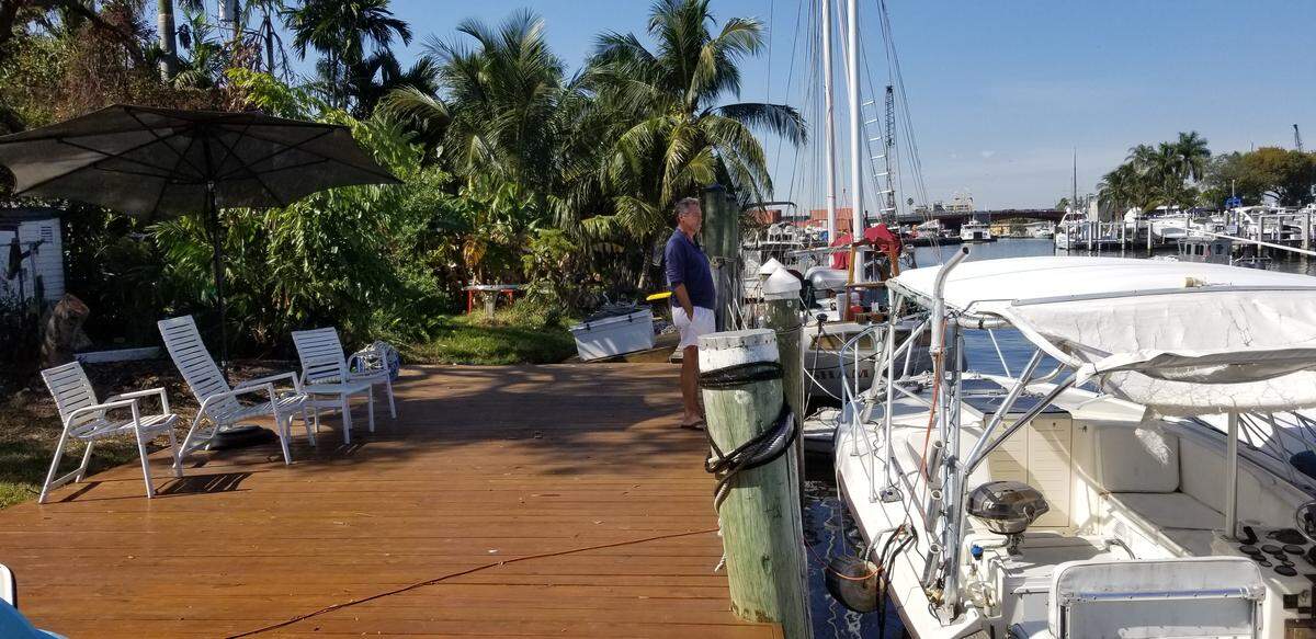 Tom Kimen looks out at the Miami River from the deck in the rear of his two-bedroom home.
