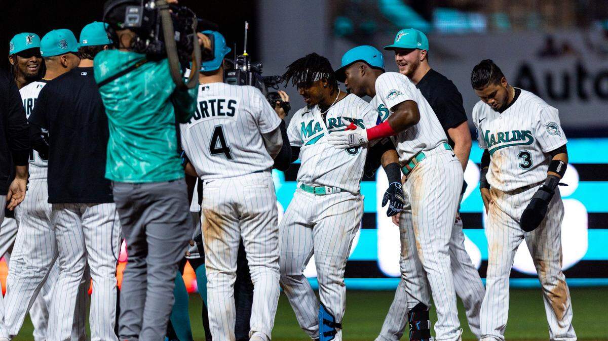 Miami Marlins batter Jean Segura (9) reacts with teammates after hitting a walk-off single during the ninth inning of an MLB game against the Chicago Cubs at loanDepot Park, in Miami, Florida, on Friday, April 28, 2023. The Marlins won 3-2 over the Cubs.