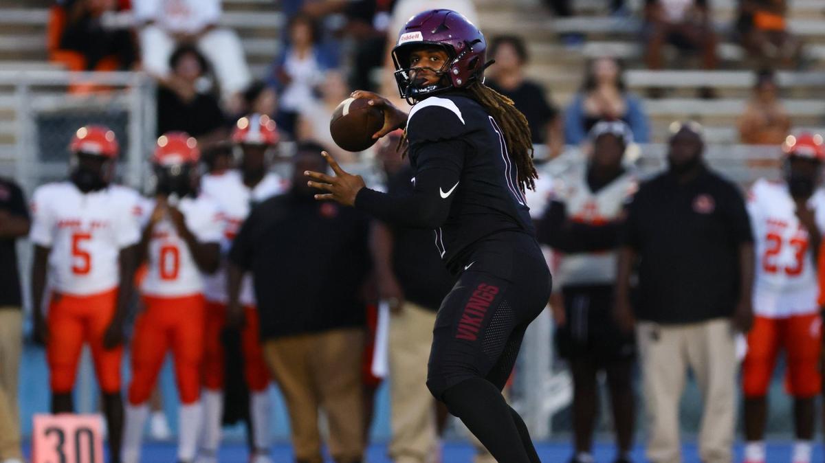 Norland Vikings quarterback Ennio Yapoor (17) throws the football against the Carol City Chiefs during the first quarter of a high school football game at Nathaniel Traz Powell Stadium.