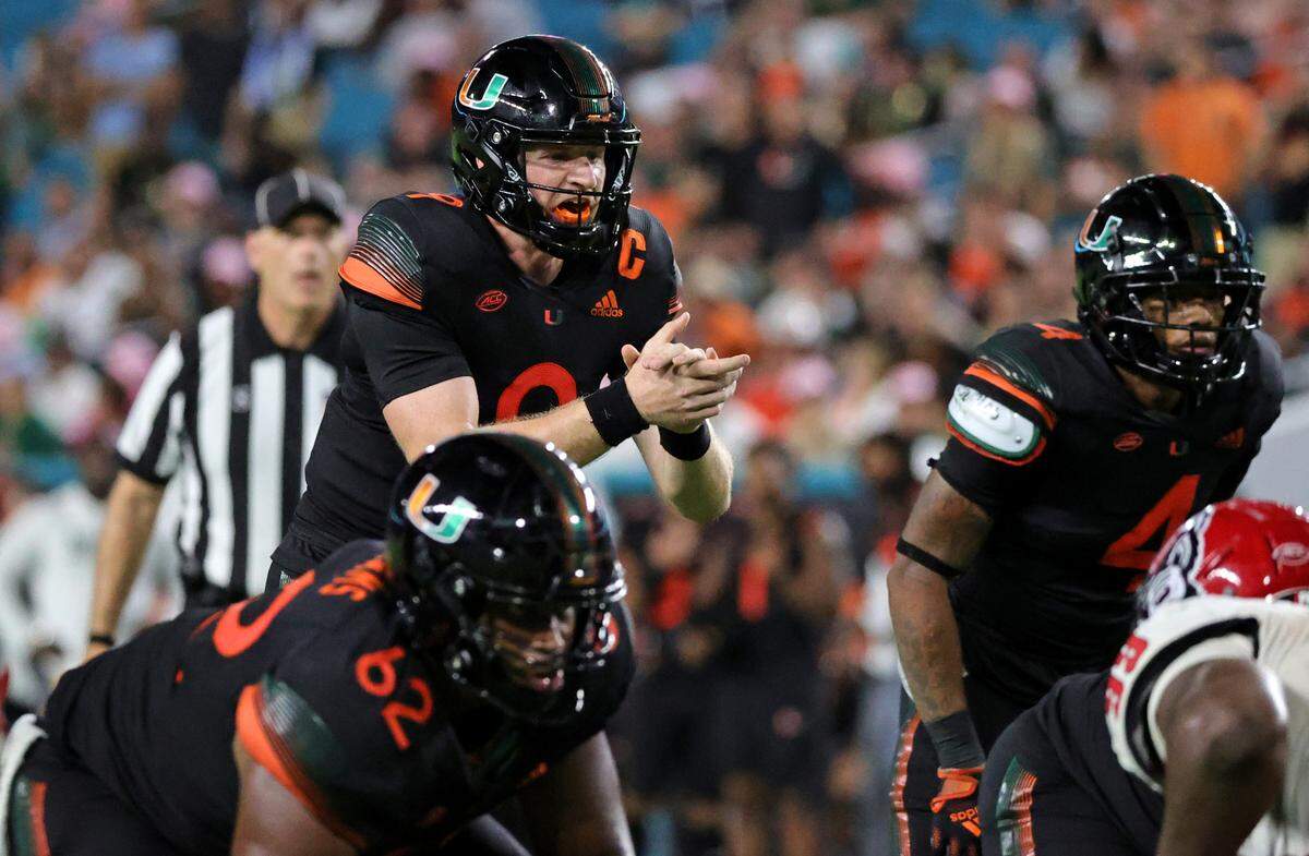 Miami Hurricanes quarterback Tyler Van Dyke (9) calls a play during the fourth quarter of their ACC football game against the North Carolina State Wolfpack at Hard Rock Stadium on Saturday, October 23, 2021 in Miami Gardens, Florida.