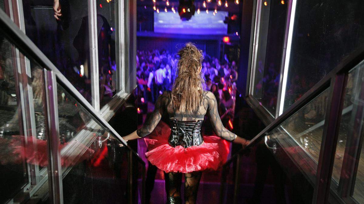 A clubgoer gets down the stairs at the private opening of Shock Nightclub in South Beach in 2010.