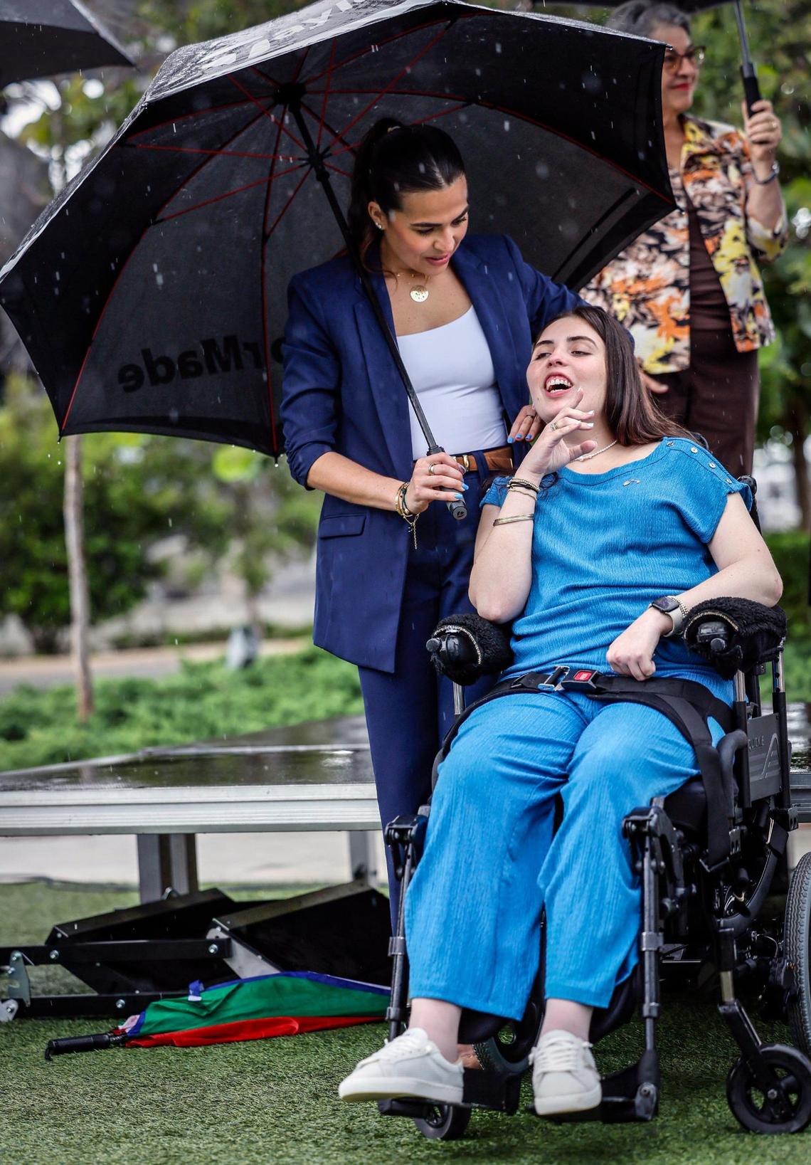 Amanda Puig stands next to her sister, boating accident survivor, Katerina “Katy” Puig, who reacts, as Melissa Fernandez, the mom of Luciana “Lucy” Fernandez, speaks during an event commemorating the July 1 enactment of Lucy’s Law at Bayshore Club in Miami, Florida, on Wednesday, July 2, 2025. Lucy, then 17, died after George Pino crashed his boat into a concrete channel marker in Biscayne Bay on Sept. 4, 2022.