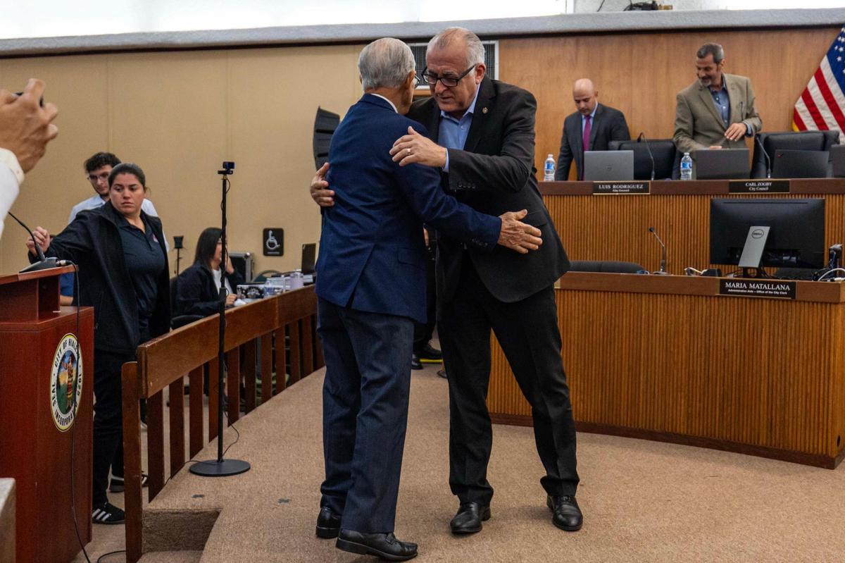 Mayor Esteban “Steve” Bovo congratulates Juan Francisco Junco afterhje was appointed as an interim council member on Tuesday, Nov. 12, 2024.