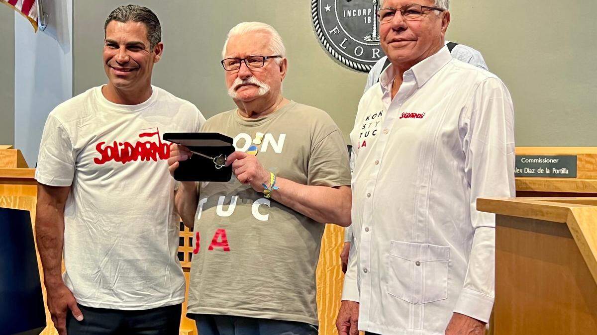 Miami Mayor Francis Suarez, left, and Commissioner Manolo Reyes, right, presented the key to the city to former Polish President Lech Walesa, center, on Wednesday, Aug. 7, 2022. Walesa was a key figure in the fall of communism in Eastern Europe and supports efforts to end the communist rule of Cuba.