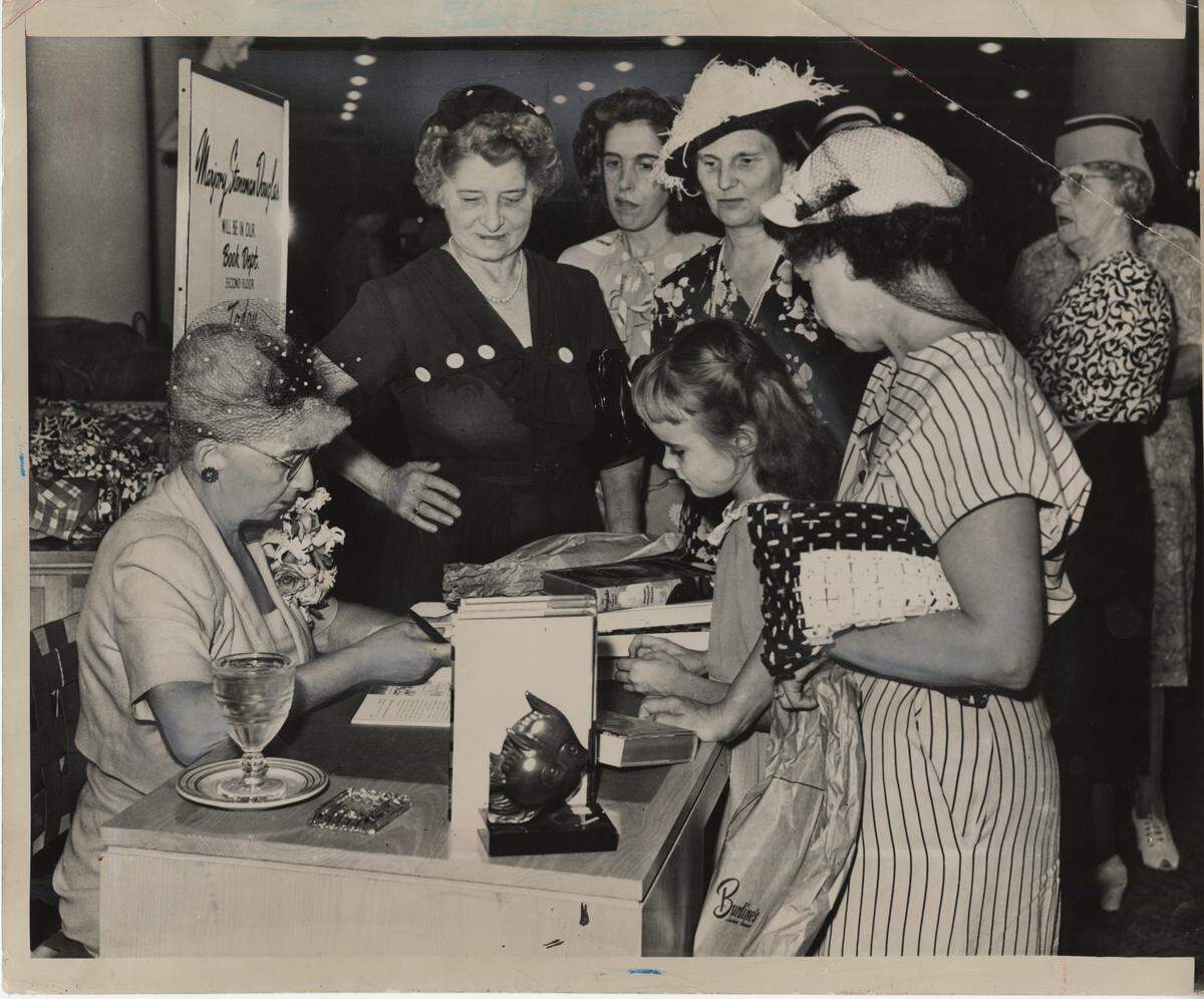 Marjory Stoneman Douglas, left, autographs her new book in the Burdines department store in downtown Miami in 1947. She signs for Jean Wall, 7, and Mrs. Jack Wall, of 1744 Allapattah Drive.