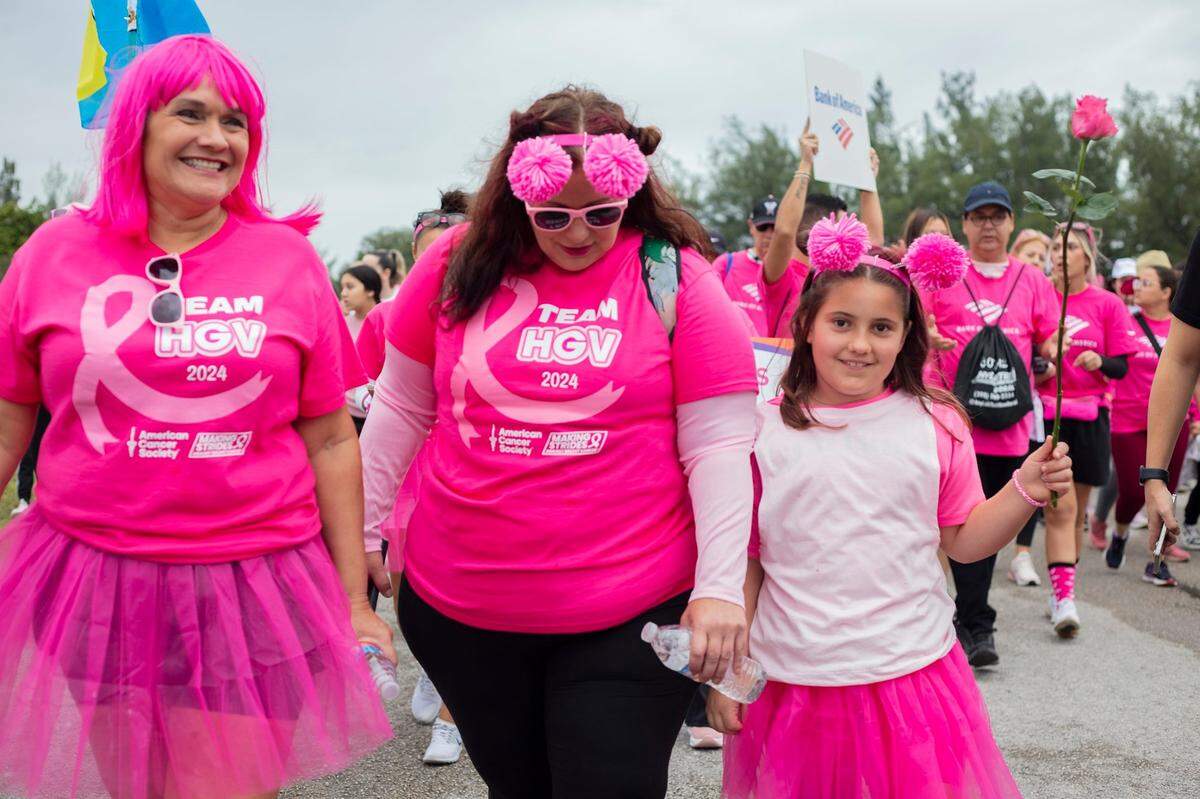 From left to right, Sharon Glenn, Jasmyn Holmes and Jadeen Holmes, 8, walk during the Pink Breast Cancer walk at Amelia Earhart Park in Hialeah on Saturday Oct. 19, 2024.