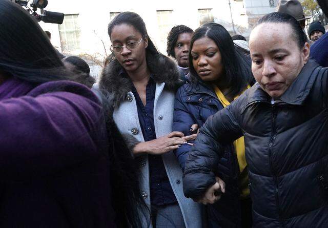 Metropolitan Correctional Center guard Tova Noel (yellow  shirt) surrounded by supporters leaves federal court in New York on Nov. 25, 2019. Tova Noel was charged in 2019 with falsifying prison records on the night Jeffrey Epstein died in his cell at the federal detention center in Manhattan. The charges were eventually dropped.