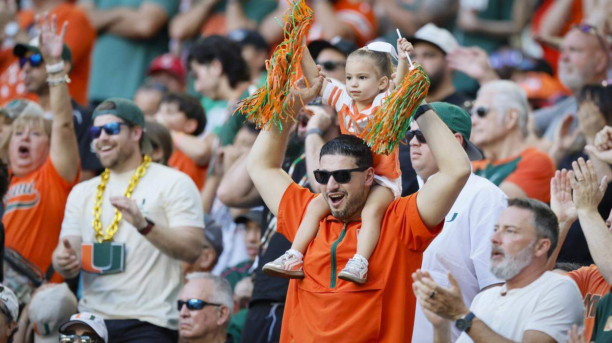 Miami Hurricanes fans show their support in the second half of an NCAA football game against the NC State Wolfpack at Hard Rock Stadium in Miami Gardens, Florida, on Saturday, November 15, 2025.