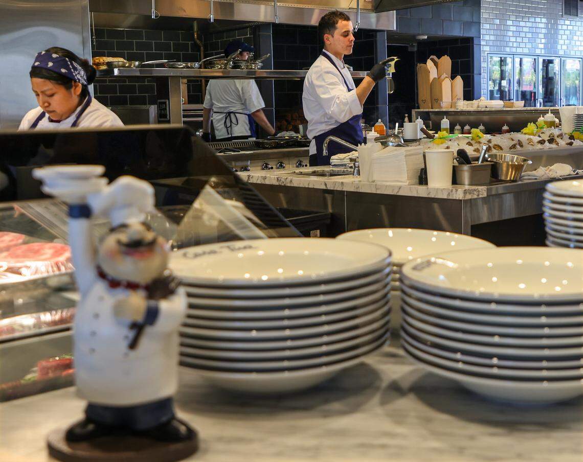 Casa Tua's open kitchen is buzzing with activity as the staff preps, cooks, and serves authentic Italian cuisine to the busy lunch crowd on Thursday, April 19, 2026, in Miami, Florida. Casa Tua Cucina in Wynwood, a spacious, upscale Italian food hall and restaurant features an open layout with high ceilings, communal tables, and multiple dedicated dining areas-making it suitable for both intimate dinners and larger group gatherings.