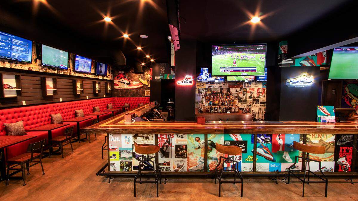 The interior at the sneaker-themed Grails sports bar in Wynwood includes 60 televisions.