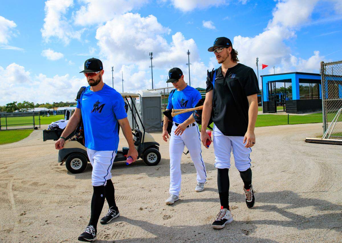 Miami Marlins infielders Jon Berti, Joey Wendle and Brian Anderson walk during their spring training workout at Roger Dean Stadium on Wednesday, March 16, 2022 in Jupiter, FL.