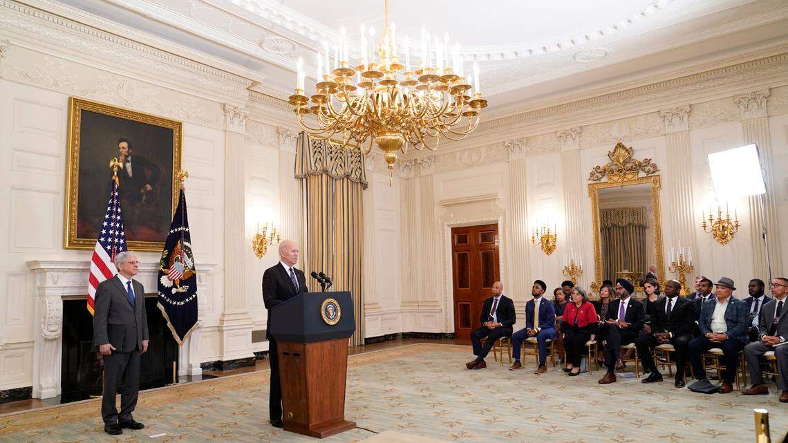 President Joe Biden speaks during an event in the State Dining room of the White House in Washington, Wednesday, June 23, 2021, to discuss gun crime prevention strategy. Attorney General Merrick Garland listens at left. Miami-Dade County Mayor Daniella Levine Cava, wearing a red jacket, is seated in the group to the right.