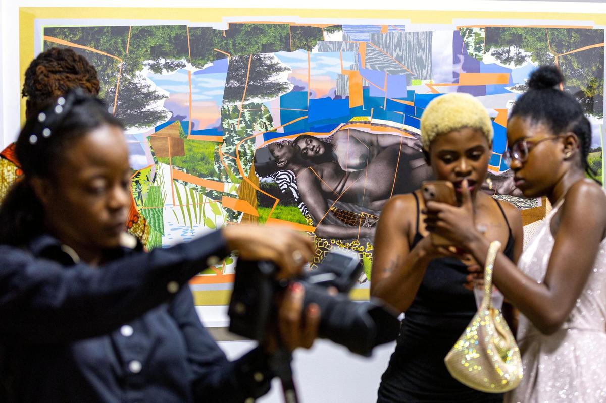 People socialize and view artwork during the Preview for The Art of Transformation event at The ARC and Logan Building in Opa-locka in November 2022. The event was a five-day, three-block Mecca of African and Haitian art fair coinciding with Art Basel Miami Beach.