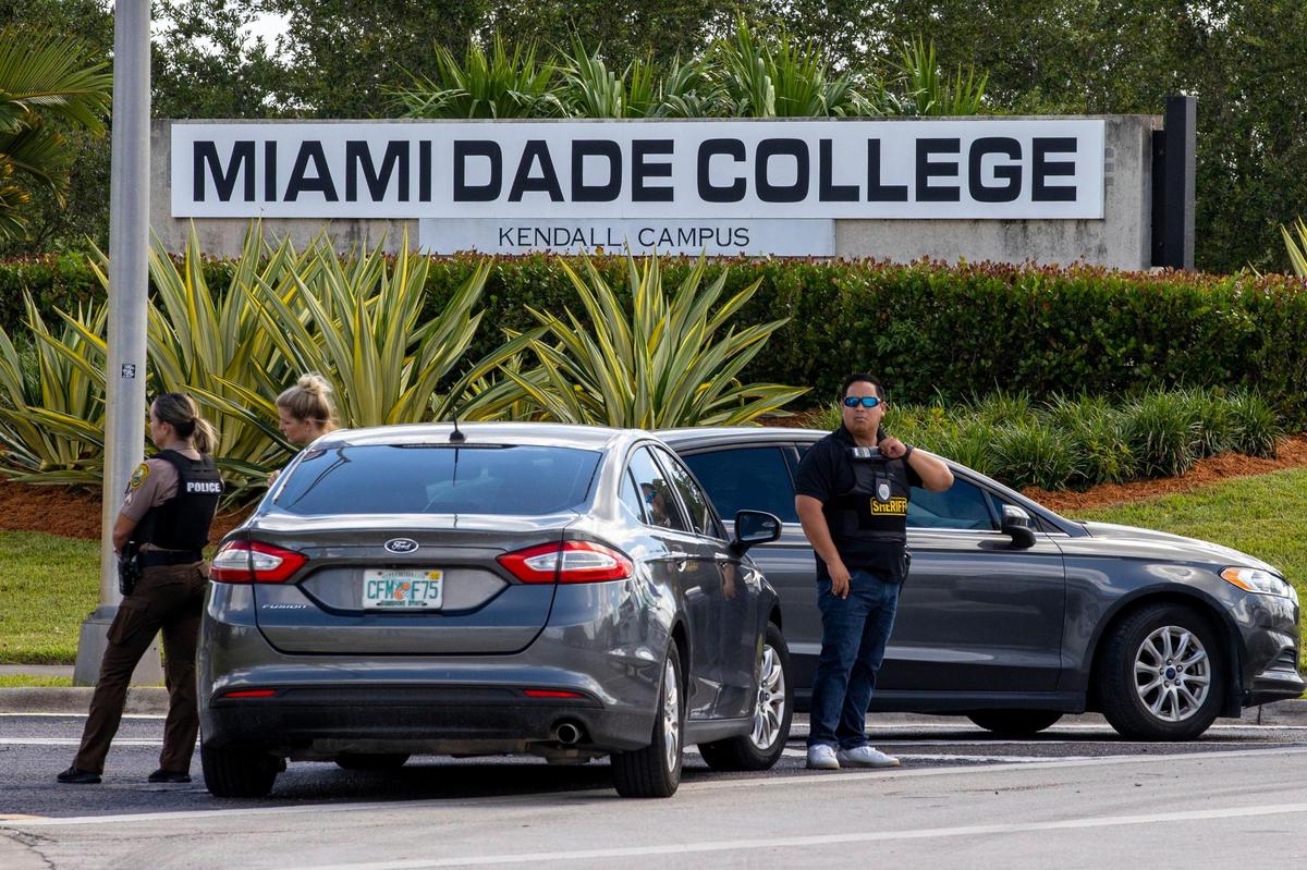 Miami-Dade Police officers block the main entrance to Miami-Dade College Kendall Campus as a part of a lockdown protocol in response to a suspicious bicyclist near campus, in Miami, Florida, on Wednesday, August 17, 2022.