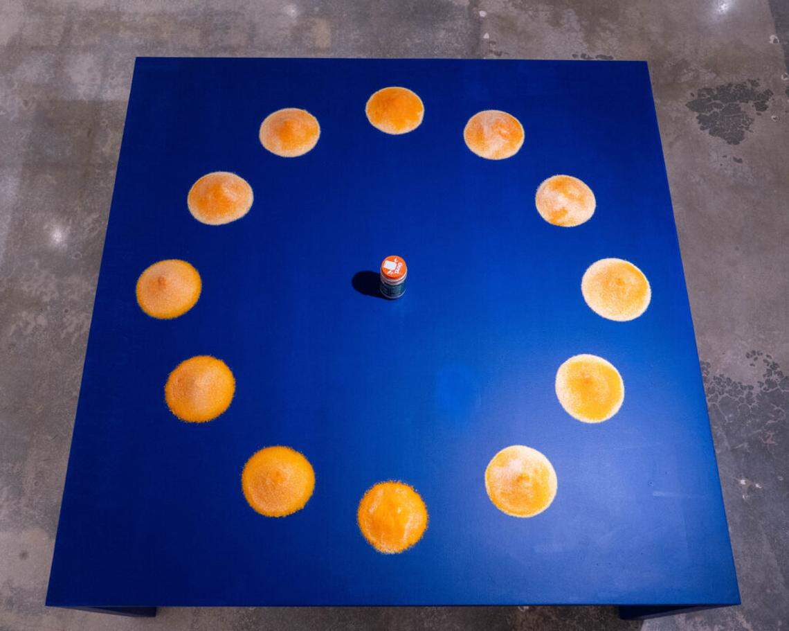 Untitled (Tang): An original 1960s bottle of Tang powdered orange drink, surrounded by twelve scoops of current day Tang orange powder.