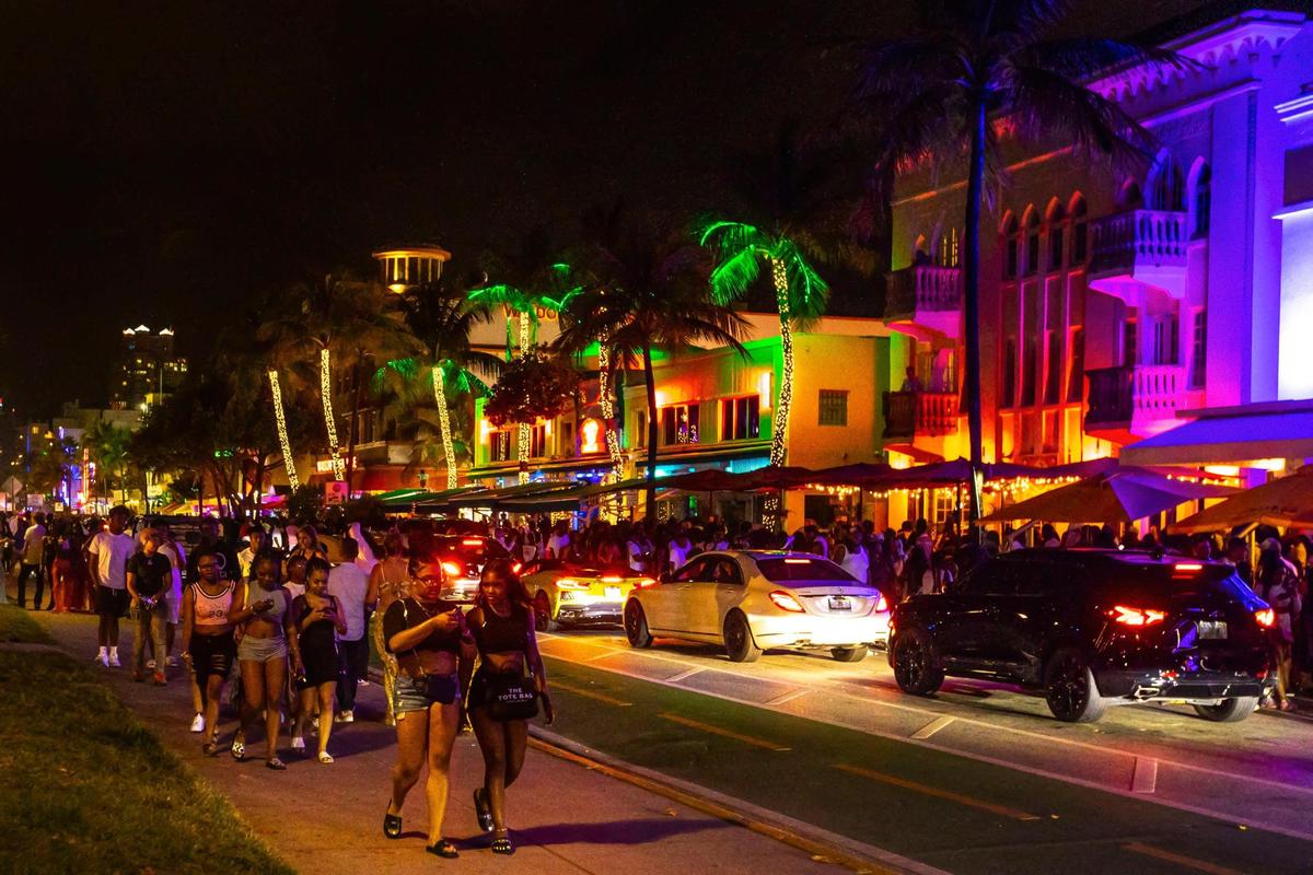 Crowds fill the sidewalks along Ocean Drive during spring break in Miami Beach on Sunday, March 20, 2022.