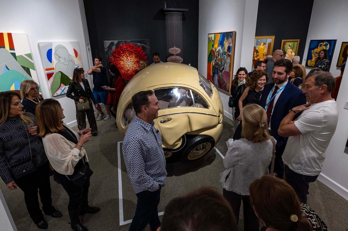 Guests walk round and ‘Booth AM 324’ by artist Ichwan Noor during Art Miami at One Herald Plaza on Tuesday, Dec. 3, 2024, in Miami, Fla.