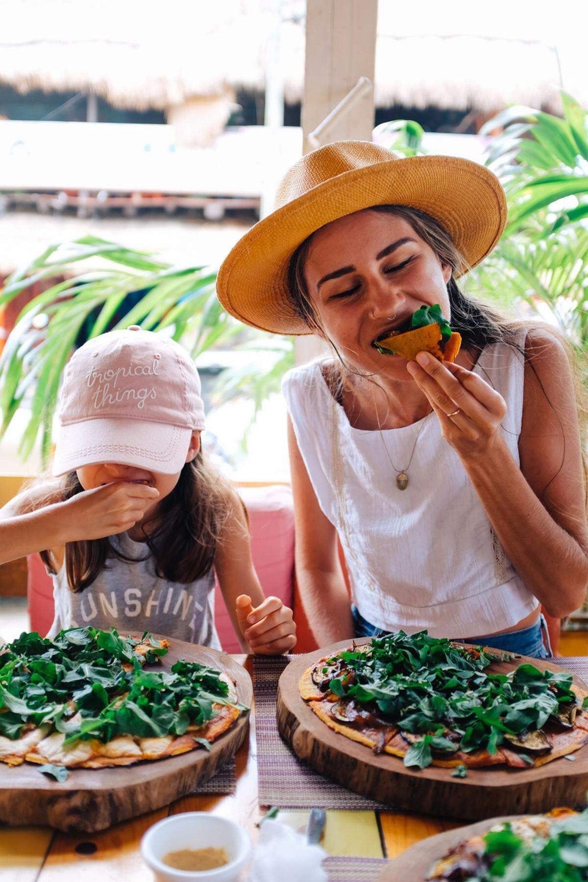 Andrea Duclos and her daughter, Marlowe, 7, are devouring a vegan pizza at the vegan restaurant, Clorofila, in Playa Del Carmen, Mexico.