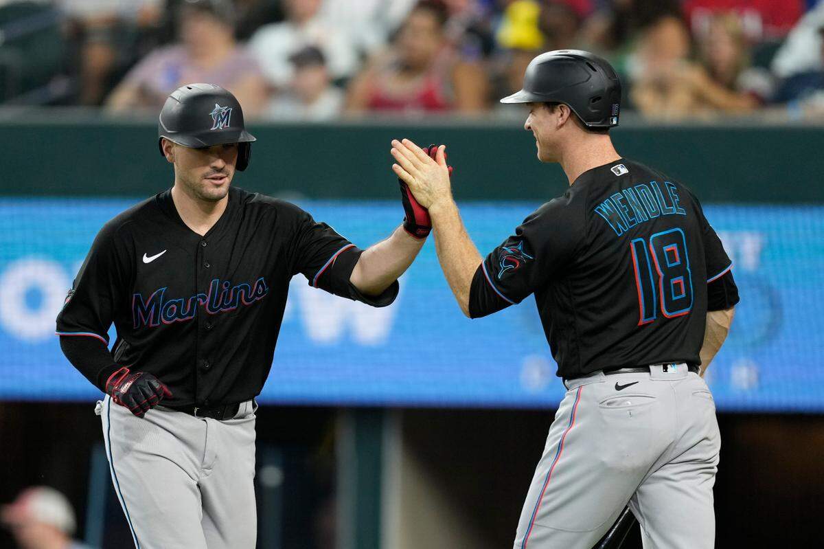 Aug 5, 2023; Arlington, Texas, USA; Miami Marlins catcher Nick Fortes (4) celebrates his home run with shortstop Joey Wendle (18) against the Texas Rangers during the sixth inning at Globe Life Field. Mandatory Credit: Jim Cowsert-USA TODAY Sports