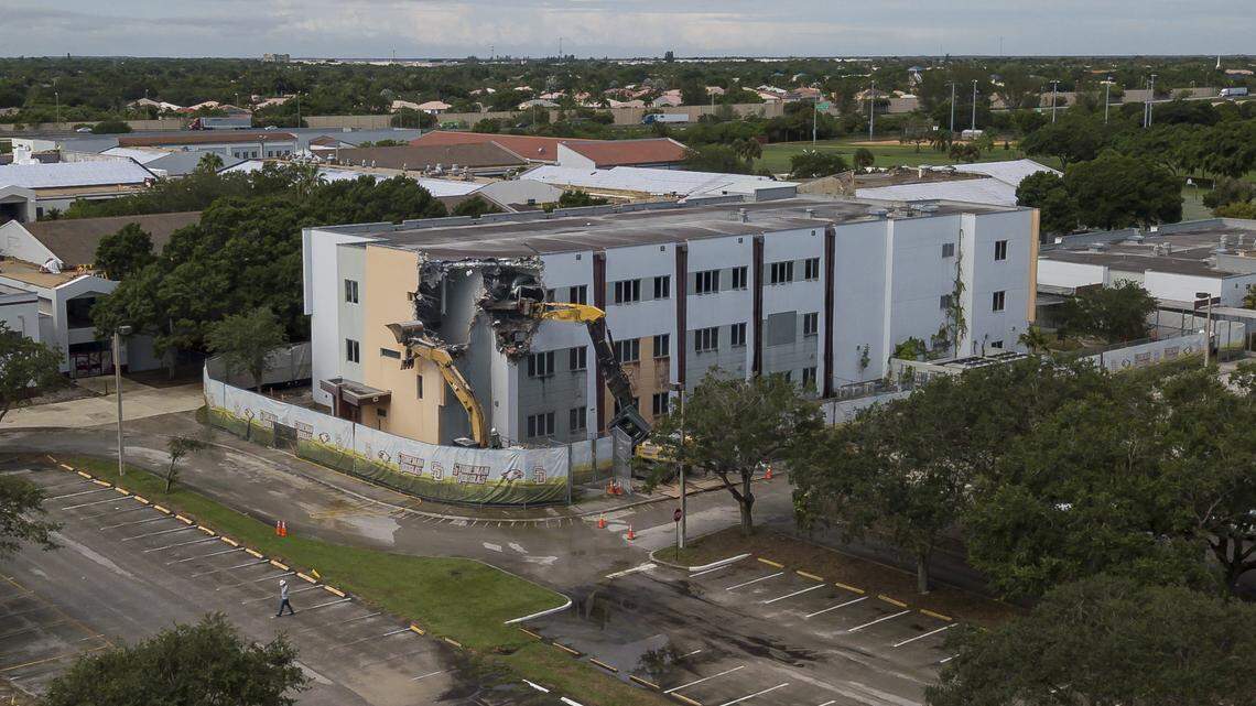 Crews use heavy equipment to tear down the 1200 building of Marjory Stoneman Douglas High School on Friday, June 14, 2024, in Parkland, Fla. On February 14, 2018, a gunmen entered the school and killed 17 people.